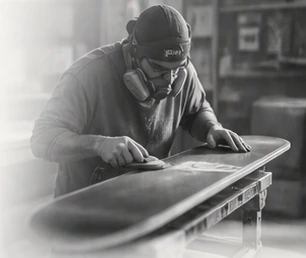 A Never Summer craftsperson building a snowboard in Denver